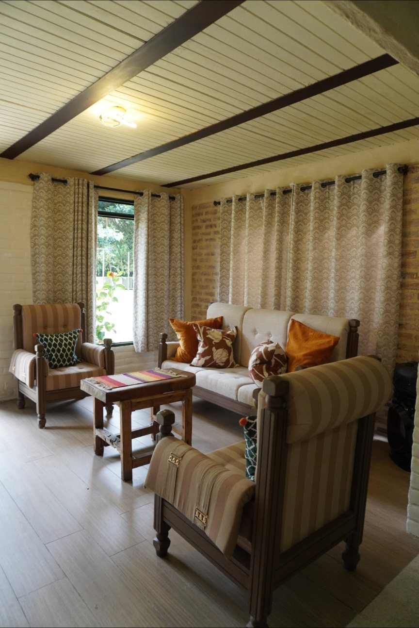 Sala de la cabaña de Wailele con sillones y luz cálida